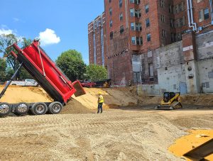Truck dumping fill material on construction site
